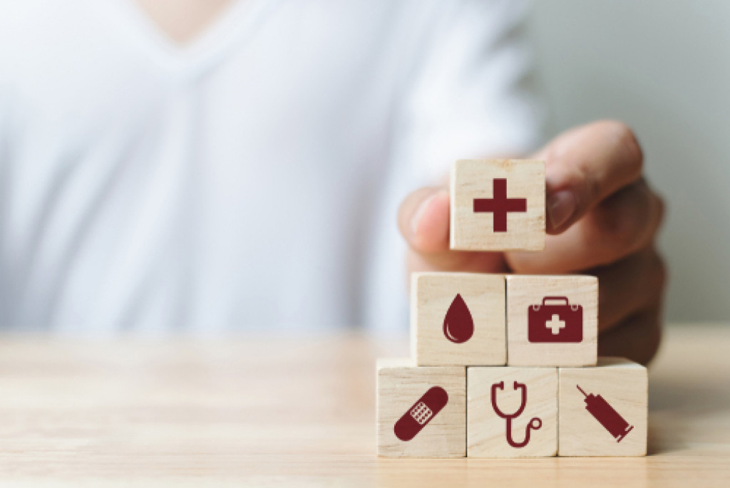 man stacking a cube with icons related to healthcare