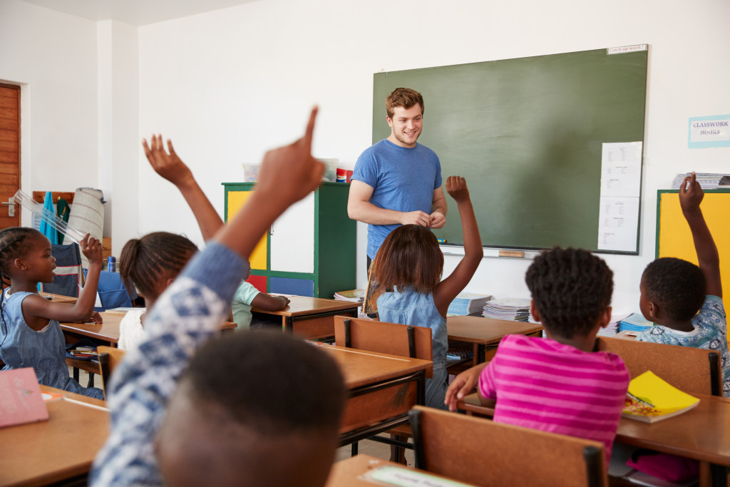man teaching kids in a classroom