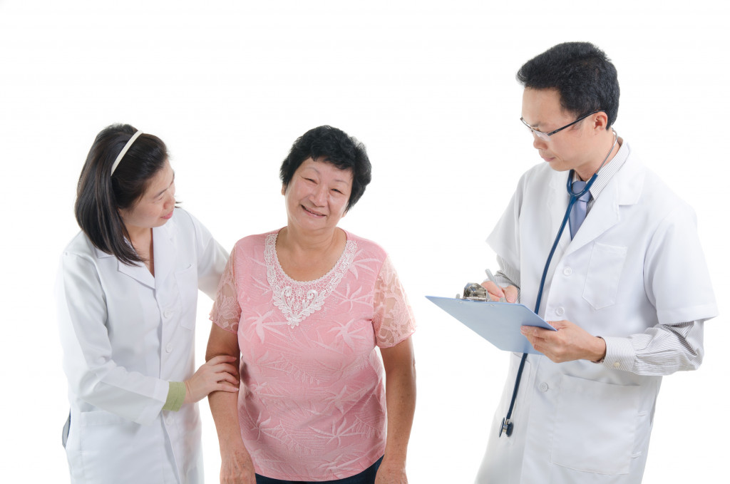 asian senior female medical checkup with doctors ,south east asian chinese ethnicity